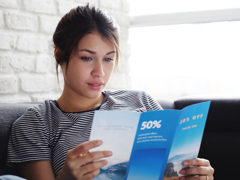 woman looking at brochure