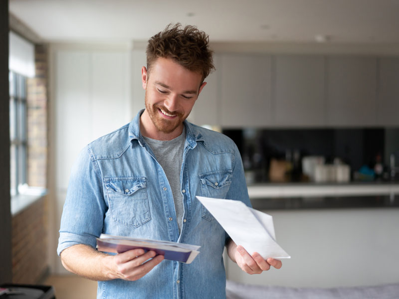 man looking at mail