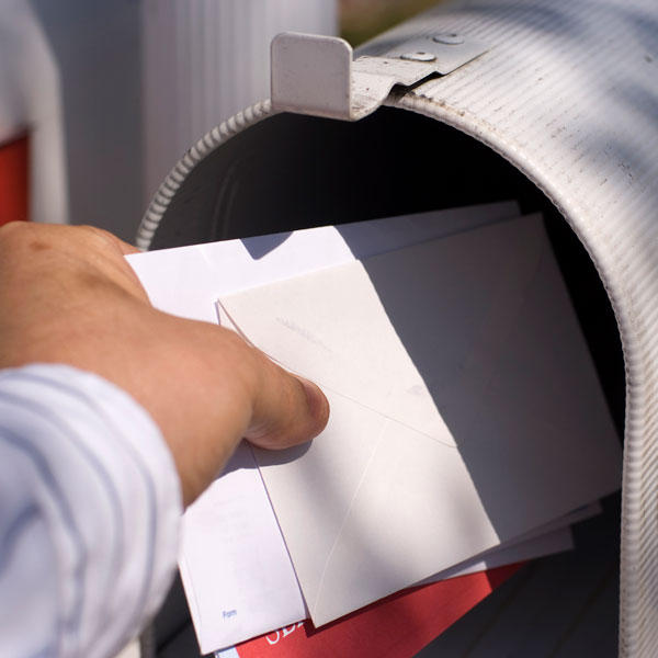 man taking mail out of mailbox