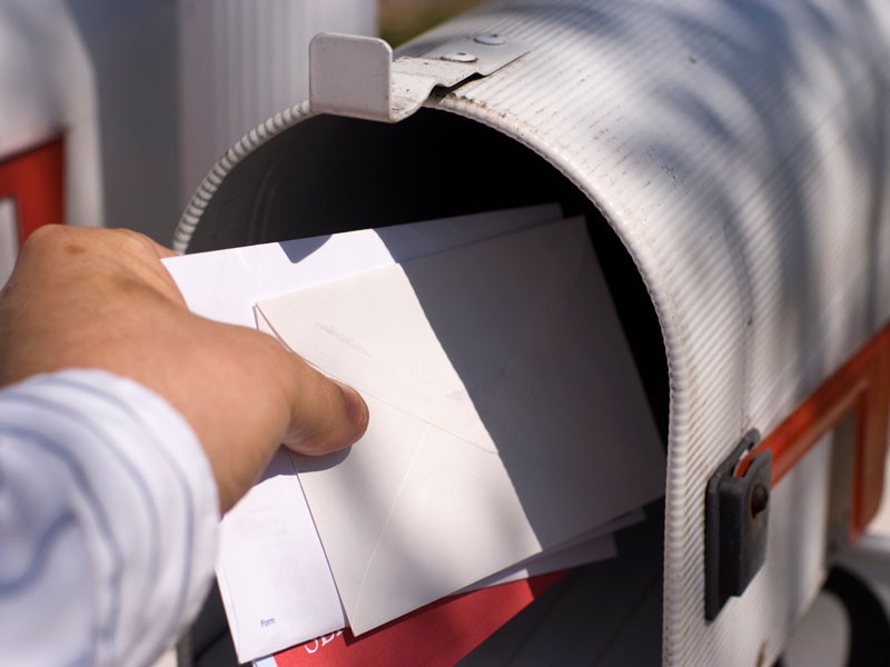 man taking mail out of mailbox